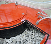 Picture 4: Top view of the processing tank of a vibratory finishing unit of 330 lt. capacity, with QF media inside and the relative feeding piping for the automatic dosage of "microfluid" gel compounds
