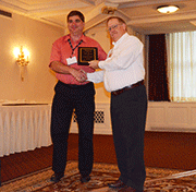 Alex Pohoata of Honeywell Aerospace receives an award from Kevin Ward, Nadcap Management Council Chair