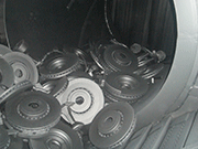 Brake discs passing through the apron conveyor inside a CT machine