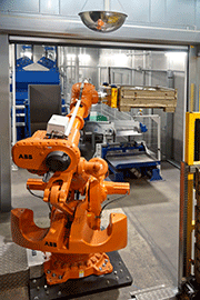 View of the blasting cell, with robot, blasting machine and conveyors