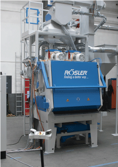 The RMBC 4.2-HD was painted per customer specifications and is equipped with special technical features. These allow the perfect blast cleaning of the compression springs as preparation for the subsequent coating process. To neutralize oil carried into the shot blast machine by the work pieces, the machine can be equipped with a dosing system for the application of a powder compound that catches and discharges the oil.
