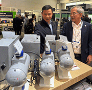 Peening Accessories GmbH introducing its 3rd generation of media flow valves. Michael Chen (left), CEO of Kunshan Carthing Precision, China, who promoted his products at the fair talking with S.H. Tan, Executive Chairman of Abrasive Engineering.