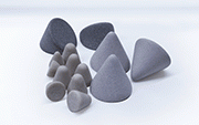 Dry deburring/surface grinding  operations are performed using an "open-structure" plastic media filled with abrasives such as quartz or zirconium