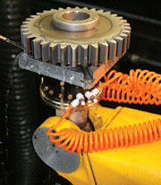 Figure 1: A spur gear being laser peened in the process cell