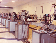Figure 1a and b:  The laser at Battelle for fusion physics and used for initial laser peening studies conducted at Battelle: a) electronics, b) laser heads.